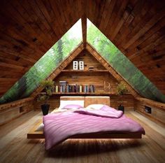 an attic bedroom with wooden walls and flooring