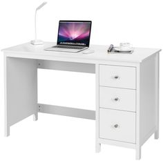 a white desk with a laptop on it