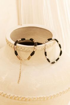 This Beautifully handcrafted choker necklace consists of 9 Tuareg Inspired motif beads. The Amari sits beautifully on it’s own, or layered to create a classy ethnic look for any occasion. You will want to wear this piece each and everyday. Includes extension chain for desired length . The Amari choker is a smaller beaded version to the Zaire choker ,if you would prefer this custom made with a different length please send me info via Dm . DETAILS :* Made from strong cotton rope string and High Quality white brass * Length of Black string with white Brass beads 33 cm* Length of extension chain 13 cm* Total length 46 cm* Width approx 1 cm* Weight 42 grams Jewelry Care : ✼ Jewelry will oxidise over time with everyday wear and exposure. Use a polishing cloth to restore shine . Avoid water and l Elegant Festival Bracelet With Tiny Beads, Bohemian Black Beaded Bracelets With Beaded Chain, Bohemian Metal Beaded Bracelets With Adjustable Chain, Gold Beads Festival Bracelet, Gold Beads Bracelet For Festivals, Gold Beaded Bracelet For Festivals, Bohemian Black Metal Beaded Bracelets, Elegant Tiny Beads Festival Bracelets, Elegant Metal Beaded Bracelets For Festivals