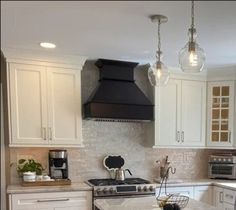 a kitchen with white cabinets and an island in front of a stove top oven, microwave and dishwasher