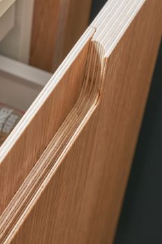 a close up view of a wooden door with the bottom section partially open, showing wood grain