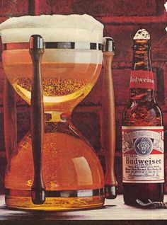 an advertisement for budweiser beer with two bottles next to it on a table