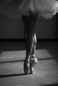 a ballerina's legs and shoes in black and white