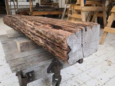 a large piece of wood sitting on top of a wooden table next to some metal brackets