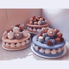 three tiered cakes decorated with teddy bears and other items on top of each cake