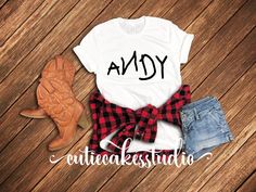 an adorable shirt that says andy on the front and plaid bow tie at the back