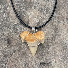 This fossil shark tooth is set in silver-plated copper anti-tarnish wire and comes with your choice of a: 16" silver tone snake chain 18" silver tone snake chain 18-20" brown faux leather cord 18-20" black faux leather cord I slip the pendant into a jewelry pouch and place that in a gift box tied with a ribbon --all ready for gifting. Adjustable Silver Arrowhead Necklace, Silver Adjustable Arrowhead Necklace, Shark Tooth Pendant, Tooth Pendant, Shark Tooth, Shark Teeth, Jewelry Pouch, Snake Chain, Black Faux Leather