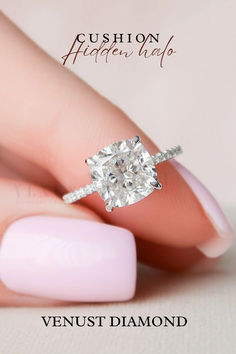 a woman's hand with a ring on her finger and a diamond in the middle