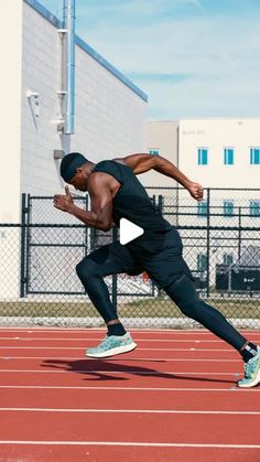 a man running on a track in front of a building