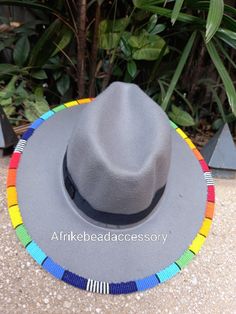 Beautifully beaded fedora hat. Best summer gift for yourself and your loved once. Available in different colours Wholesale is also available. Shipping is via DHL EXPRESS with a GUARANTEED delivery between 3-5 days worldwide. **BUY MULTIPLE ITEMS, PAY SHIPPING ONCE** FREE SHIPPING FOR ALL ADDITIONAL ITEMS IN YOUR CART Check out more fedoras from the store. variety to chose from https://www.etsy.com/shop/CaribuKenya Multicolor Beaded Brimmed Hat, Multicolor Beaded Hat With Curved Brim, Multicolor Beaded Short Brim Hat, Multicolor Bead Cap Hats For Festivals, Multicolor Bead Caps Hats For Festival, Multicolor Festival Hats With Bead Caps, Multicolor Beaded Caps Festival Hats, Multicolor Bead Caps Festival Hats, Grey Fedora Hat