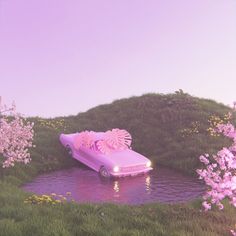 a car that is floating in the water with pink flowers on it's hood