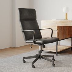 an office chair sitting on top of a rug next to a wooden desk and cabinet