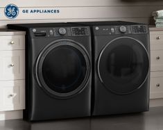 the front load washer and dryer are sitting next to each other in this laundry room