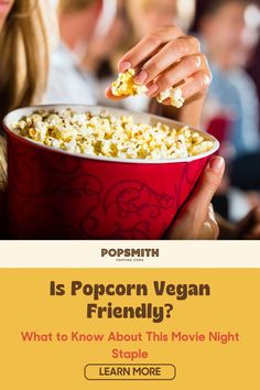 a woman is eating popcorn in a red bowl with the caption is popcorn vegan friendly? what to know about this movie night staple learn more