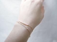 "Double strand beaded bar bracelet - dainty jewelry Tiny baby pink beads beaded on 14K gold filled chain. Double chain bracelet that's femininely dainty in soft shades of gold and blushing pink. measurements bead bar length 1\" please choose length at checkout ♦you can enter shop here! http://etsy.com/shop/illusy" Dainty Yellow Gold Beaded Bracelets In 14k Gold Filled, Everyday 14k Gold Filled Beaded Bracelets With Tiny Beads, Dainty Gold Beaded Bracelets, Dainty 14k Gold-filled Beaded Bracelets, Adjustable Delicate 14k Gold Beaded Bracelet, Delicate Adjustable 14k Gold Beaded Bracelet, Delicate Gold Bracelet With Satellite Chain, Dainty 14k Gold Bracelet With Tiny Beads, Dainty Rose Gold Bracelet, 14k Gold Filled