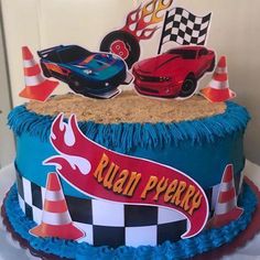 a birthday cake decorated with cars and cones