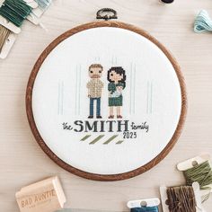 a cross stitch pattern with two people holding each other and the words, the smith family on it