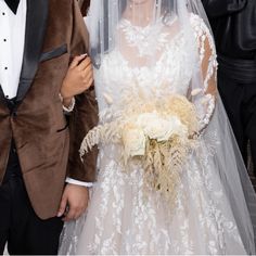 a bride and groom walking down the street