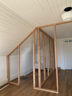 an unfinished room with wood framing in it