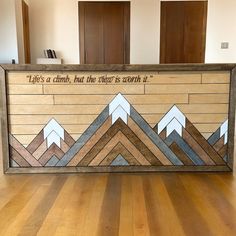 a wooden sign with mountains on it that says life's a climb, but the choice is not it