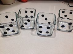 four glass dices sitting on top of a table