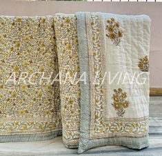 two bedspreads with yellow and white flowers on them are next to each other