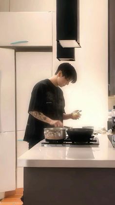 a man cooking food on top of a stove