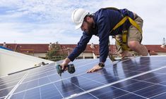 a man working on a solar panel roof