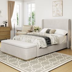 a bedroom with a large bed and white walls