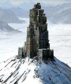 a very tall castle sitting on top of a snow covered mountain