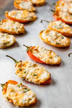 mini stuffed peppers with cheese and herbs on a baking sheet ready to go into the oven