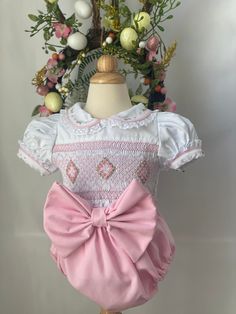 Pre-order handmade smocked romper. It takes 3-6 weeks to ship. Thank you for your patience. Thank you for supporting a small business. Clothing Care Instructions Most items can be washed safely in cold water on delicate cycle and hung to dry. If the item that you are ordering has red or another bright color in it next to a white or other light color fabric please use a Shout color catcher for the first few washes to avoid bleeding. The reds are pre-washed but they are still red and will likely h Cotton Fitted Bubble Romper With Smocked Back, Spring Bubble Romper With Smock Detail, Spring Fitted Smocked Bubble Romper, Cute Pink Bubble Romper With Smocked Back, Spring Fitted Smock Bubble Romper, Cute Pink Bubble Romper With Smocked Bodice, Fitted Smock Bubble Romper For Summer, Fitted Pink Embroidered Smocked Dress, Fitted Pink Smocked Dress With Embroidery