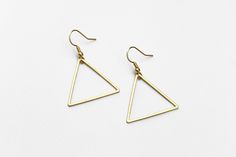 "Lightweight, geometric triangle earrings perfect for your next day out in the summer sunshine. ▲ Brass triangles measure approx. 1 1/4\" ▲ Gold-plated surgical steel earring hooks (hypoallergenic) We try to display product colors as close to life as possible. However, all monitors are different and so there might be slight color variations from screen to screen. CARE INSTRUCTIONS Jewelry should be kept away from moisture as much as possible. Remember to take your jewelry off before swimming and Minimalist Earrings For Summer, Adjustable Geometric Minimalist Earrings, Adjustable Minimalist Geometric Earrings, Adjustable Minimalist Earrings For Summer, Minimalist Adjustable Earrings For Summer, Minimalist Triangle Nickel-free Earrings, Minimalist Nickel-free Triangle Earrings, Minimalist Summer Earrings With Ear Wire, Minimalist Summer Earrings