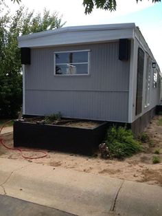 a small house with a planter in front of it