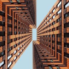 an upward view of some tall buildings