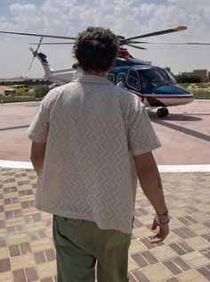 a man standing in front of a helicopter