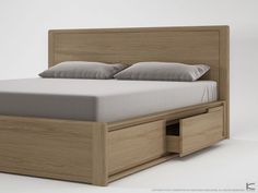 a bed with two drawers underneath it on a white surface, and the headboard is made out of wood