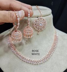 a necklace and earring set on display in a store