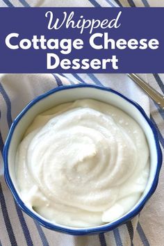 a blue bowl filled with cottage cheese dessert on top of a white and blue table cloth