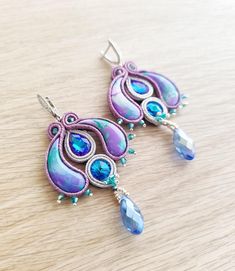 Add a touch of elegance and originality to your look with these purple and blue soutache earrings, adorned with handmade polymer clay cabochons and sparkling crystals.  Each pair is unique and crafted with care, ensuring an accessory that stands out for its beauty and uniqueness.  Wear these earrings with confidence and let their captivating design add a touch of sophistication to your personal style. Ideal gift for mom and mother's day Size about 3.14x1.77 inches (8x4.5 cm) Elegant Purple Polymer Clay Earrings, Elegant Blue Polymer Clay Earrings, Earrings With Clay, Soutache Earrings, Sparkling Crystal, Handmade Polymer Clay, Gift For Mom, Jewelry Earrings Dangle, Ideal Gift