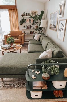 a living room filled with lots of furniture and plants on top of a coffee table