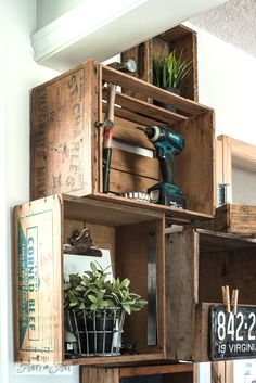 some wooden crates with plants and tools in them