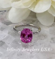 "The ring pictured is a lab created pink sapphire #6448 -Approximate total carat weight: approx. 3.00ctw diamond equivalent -Center Stone Size: 10x8mm - approx. 3.00ct diamond equivalent -Center Stone Shape: oval -Gem Type: lab created sapphire -Stone Clarity: VS2 -Stone Color: Medium Pink -Moh's Scale: 9 hardness -Metal Type and Purity: 14k white gold -Setting: 4 prong open U head -Stock Ring Size: 6 -Country of Manufacturing: USA (Michigan) For customization please contact us. If you have any Sapphire Anniversary Ring, Sapphire Solitaire Ring, Sapphire Solitaire, White Gold Set, Ring Pictures, Sapphire Engagement, 14k White Gold Ring, Sapphire Stone, Birthstone Ring