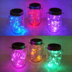 four mason jars with colorful lights in them