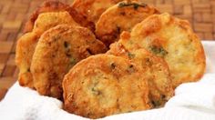 some fried food is sitting in a white basket on a table top with a napkin