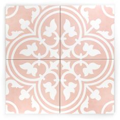 a pink and white tile with an intricate design