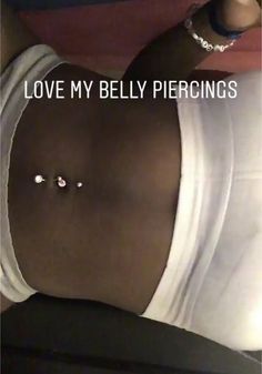 an image of a woman with piercings on her stomach that says, love my belly piercings