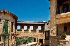 a stone building with an arched doorway and balcony