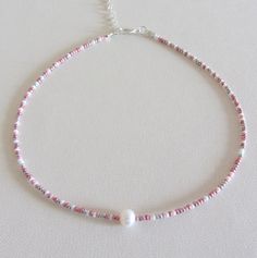 Beaded choker Pearl bead choker White pink silver rainbow delicate beaded choker necklace Adjustable pearl choker single pearl necklaces Free shipping is available for orders to the United States, with a purchase of $ 35. This beautiful necklace is made of white, pink and silver beads with one freshwater pearl. Please choose at an order length of necklace. Each choker comes with a 2 inch adjustable extender chain. Rainbow Pearl Necklace, Pink Choker Necklace, Choker Pearl, White Choker, Pink Choker, Choker Necklace Designs, Single Pearl Necklace, Rainbow Pearl, Pink Pearl Necklace