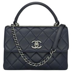 CHANEL Trendy CC Top Handle Bag Small Navy Blue Lambskin with Ruthenium Hardware 2015 – 15B. This stunning bag is in very good condition, the bag still holds its shape very well, and the hardware is still very shiny. This top handle bag is simply gorgeous in so many ways. It can be carried in multiple ways; on your hands, on your shoulder. This bag is functional, practical and easy to use as an everyday companion. - Exterior Condition: Very good condition. Light leather surface wear to the corners. The exterior shows general signs of wear- light leather creases to the back of the bag, and very light leather surface wear to the handle. - Interior Condition: Very good condition. Very clean and shows general signs of wear – a couple of very light scratches on the inner flap, and storage inden High-end Blue Shoulder Bag With Top Carry Handle, High-end Blue Bag With Double Handle, High-end Blue Bag With Detachable Handle, High-end Blue Satchel Shoulder Bag, High-end Blue Shoulder Bag Satchel, High-end Blue Shoulder Satchel, High-end Blue Evening Satchel, Blue Business Bag With Top Carry Handle, Business Blue Bags With Top Carry Handle